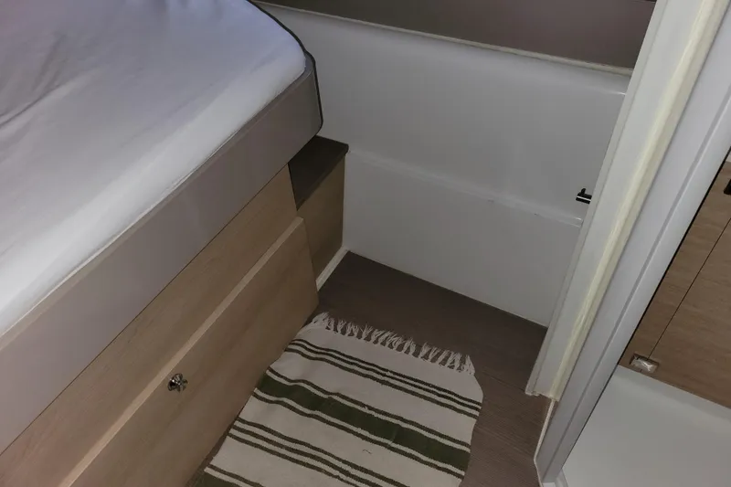 Slide: The Image of Interior of a 2019 Bali 4.3 yacht cabin with bed and striped rug. - 48