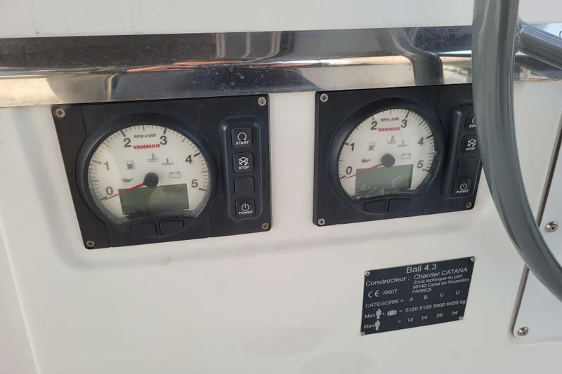 Slide: The Image of Yanmar engine gauges on a 2019 Bali 4.3 catamaran dashboard. - 52