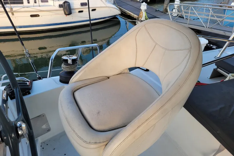 Slide: The Image of Captain's seat on a 2019 Bali 4.3 catamaran at a marina. - 53