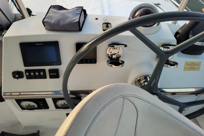 Slide: The Image of Steering console of a 2019 Bali 4.3 catamaran with navigation equipment. - 55