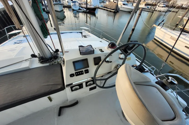 Slide: The Image of Cockpit view of a 2019 Bali 4.3 catamaran docked at a marina. - 56