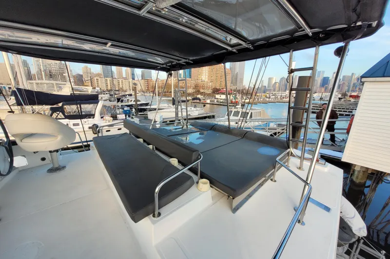 Slide: The Image of 2019 Bali 4.3 yacht with spacious deck, docked in a marina with city skyline. - 58