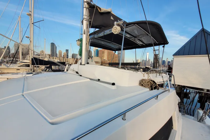Slide: The Image of 2019 Bali 4.3 catamaran docked in urban marina with city skyline. - 60