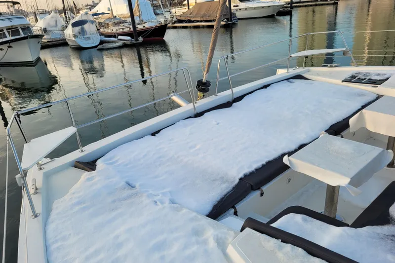 Slide: The Image of Snow-covered deck of a 2019 Bali 4.3 catamaran in a marina. - 65