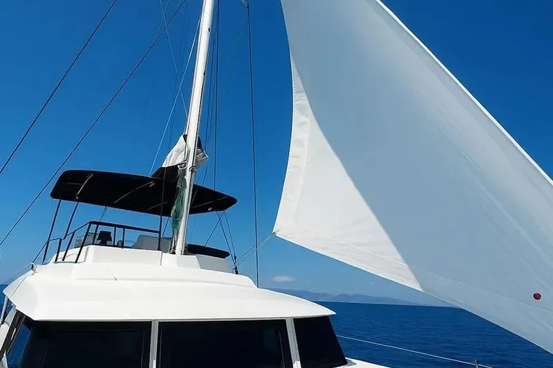 Slide: The Image of Sailing catamaran Bali 4.3, 2019 model, with white sails against a clear blue sky. - 66