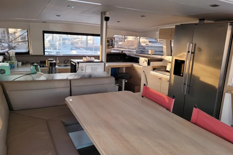 Slide: The Image of Interior of a 2019 Bali 4.3 catamaran with modern kitchen and seating area. - 8