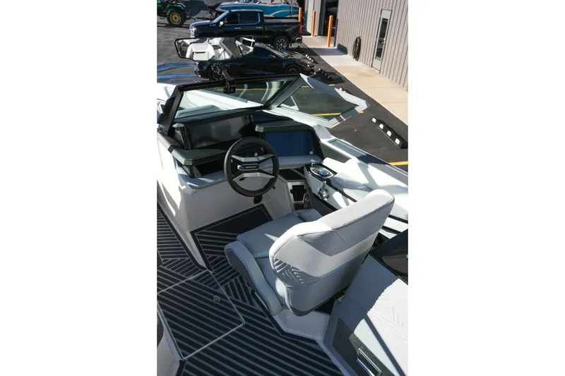 Slide: The Image of Interior view of 2026 MasterCraft XStar 25 boat, featuring modern steering and seating. - 14
