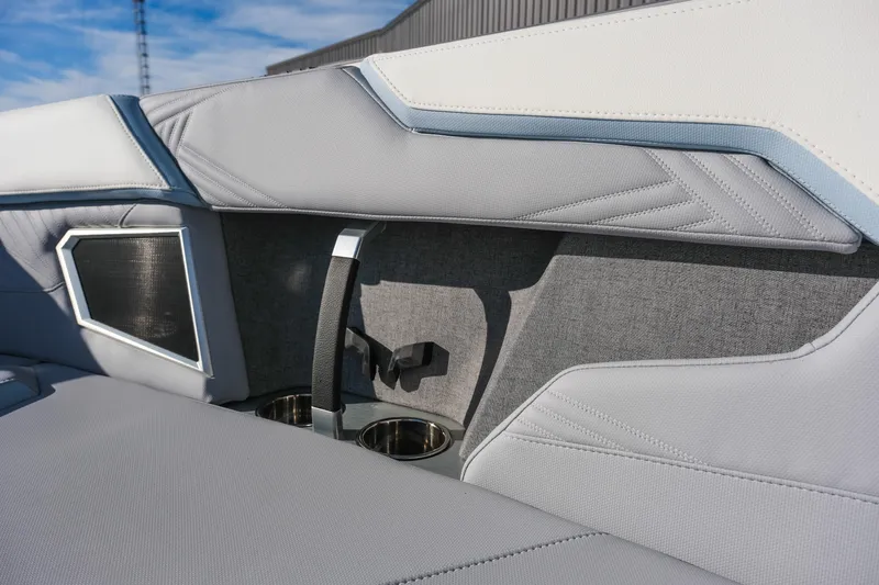Slide: The Image of 2026 MasterCraft XStar 25 interior with sleek gray upholstery and cup holders. - 16