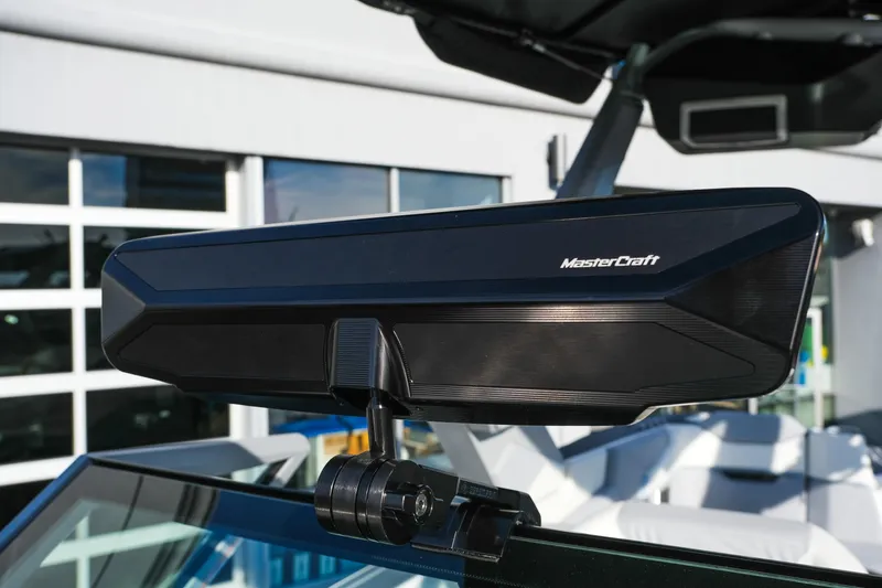 Slide: The Image of 2026 MasterCraft XStar 25 rearview mirror, sleek design, mounted on boat windshield. - 18