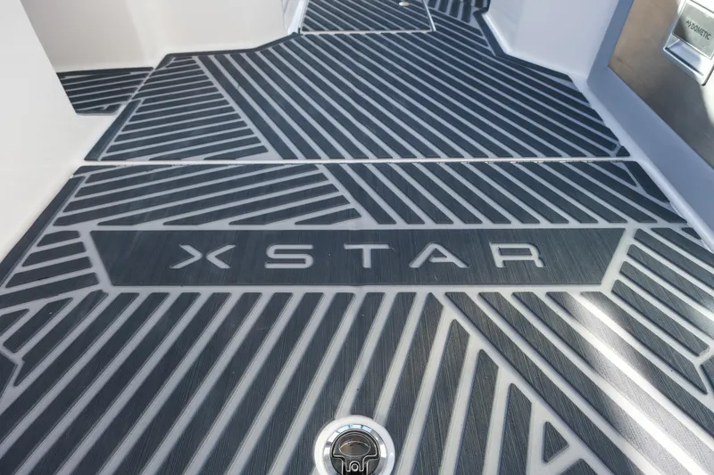 Slide: The Image of 2026 MasterCraft XStar 25 boat deck with stylish geometric pattern and logo. - 22