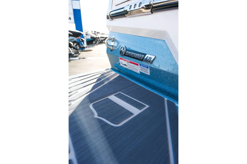 Slide: The Image of 2026 MasterCraft XStar 25 boat with supercharged 6.2L engine, rear view. - 35