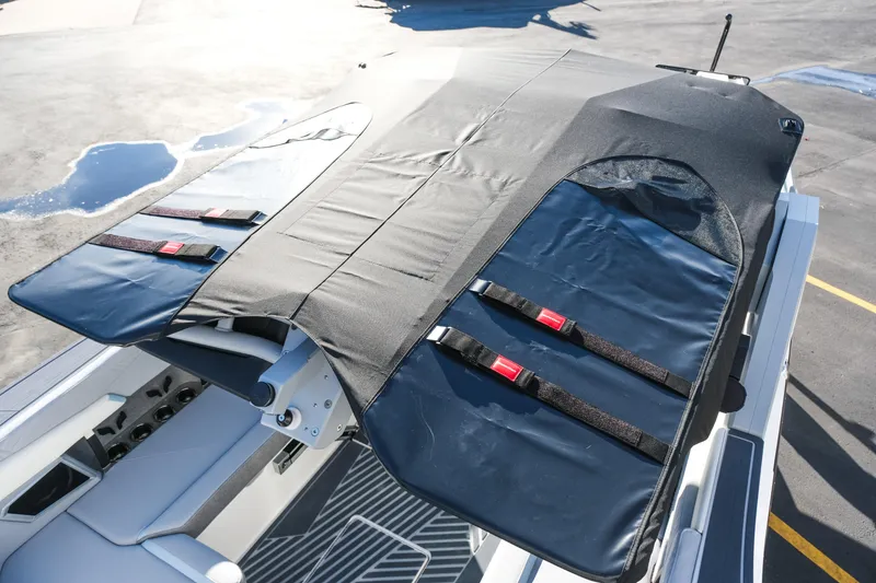 Slide: The Image of 2026 MasterCraft XStar 25 boat with covered seating and storage area. - 47