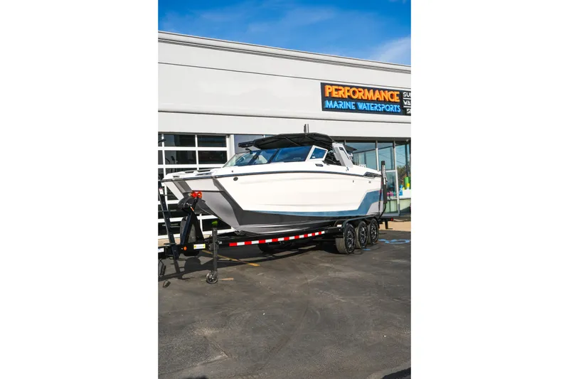Slide: The Image of 2026 MasterCraft XStar 25 boat on trailer at Performance Marine Watersports dealership. - 49