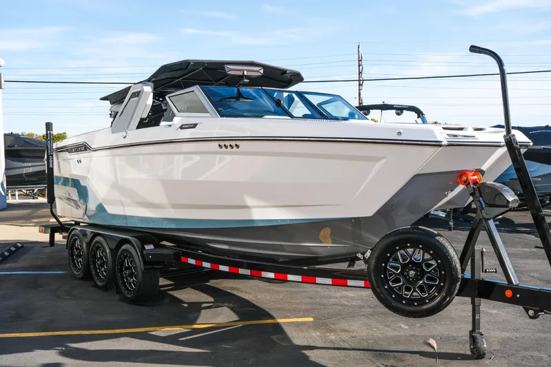 Slide: The Image of 2026 MasterCraft XStar 25 boat on a trailer, displayed outdoors. - 50