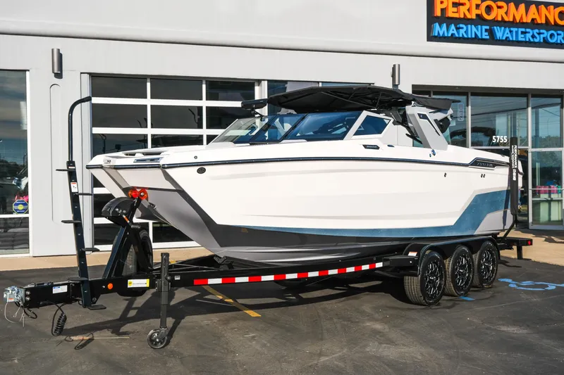 Slide: The Image of 2026 MasterCraft XStar 25 boat on trailer outside marine dealership. - 52