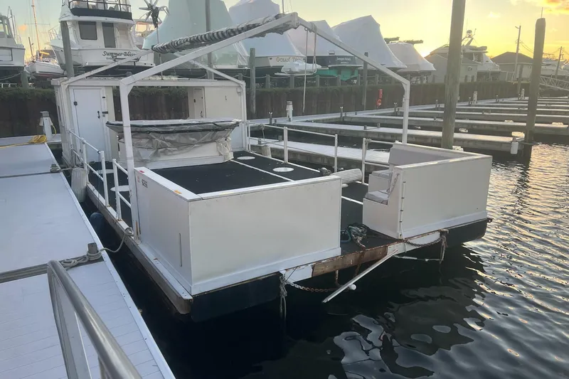 The Image of Custom MK1 2022 boat docked at marina during sunset, featuring open deck design. - 1