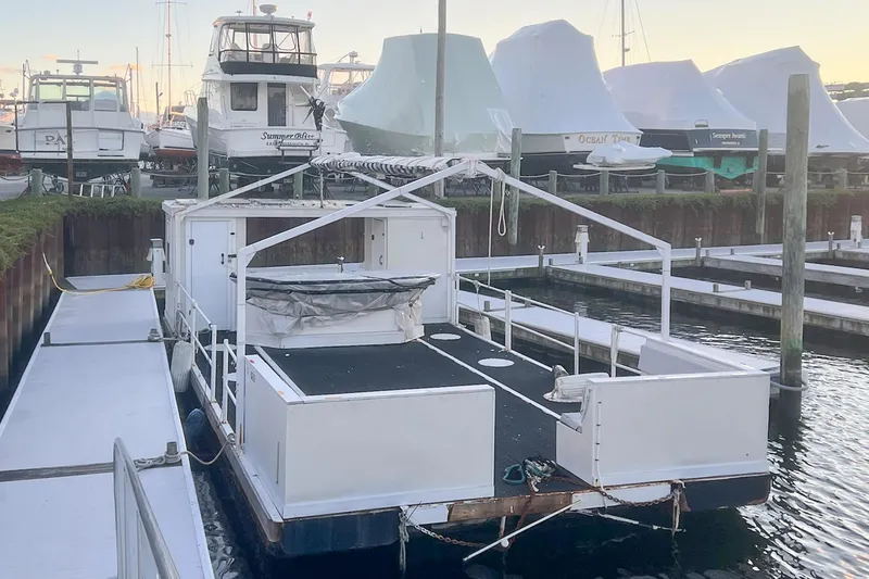 Slide: The Image of Custom MK1 2022 houseboat docked at marina, surrounded by other boats. - 5