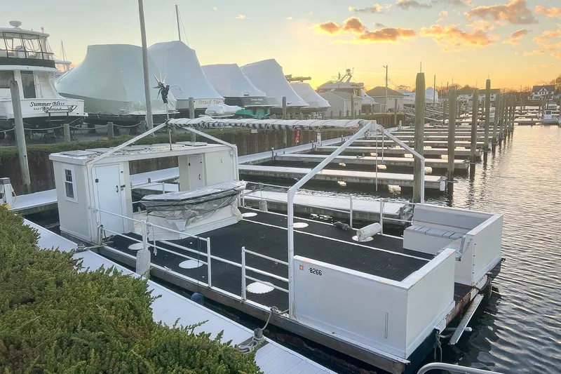 Slide: The Image of Custom MK1 2022 houseboat docked at marina during sunset, surrounded by other boats. - 6
