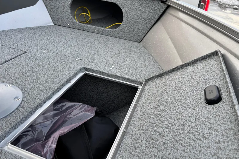 Slide: The Image of 2026 Crestliner 1650 Kodiak boat interior with open storage compartment. - 11