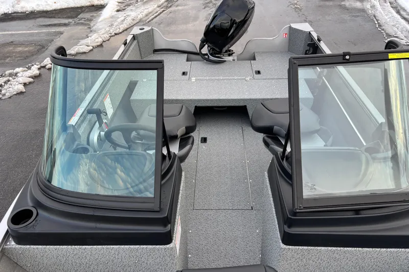 Slide: The Image of 2026 Crestliner 1650 Kodiak boat with dual windshields, parked on snowy pavement. - 12