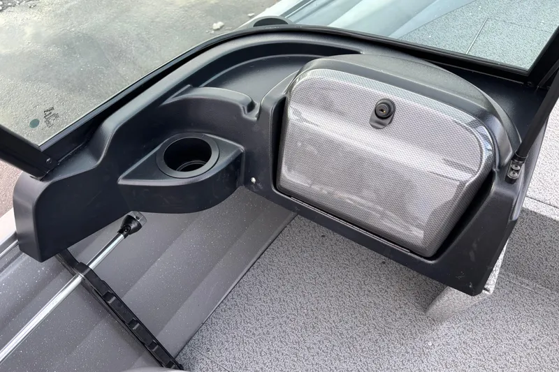 Slide: The Image of 2026 Crestliner 1650 Kodiak boat interior with storage compartment and cup holder. - 2