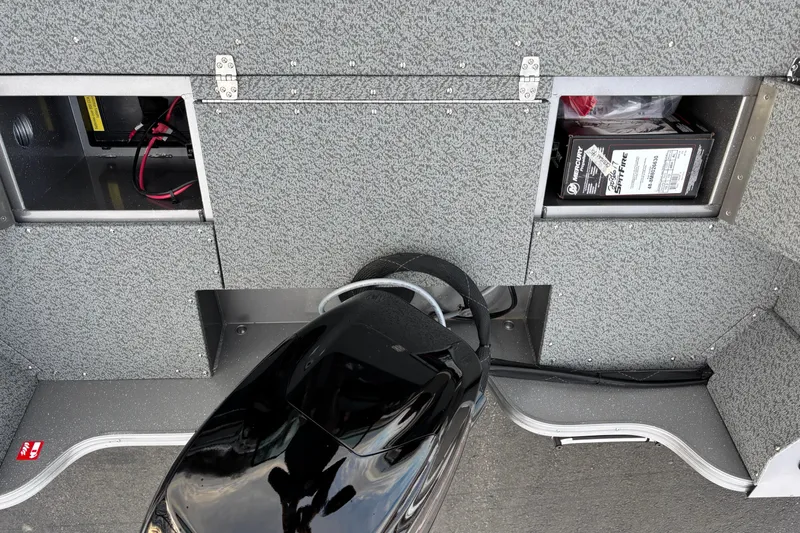 Slide: The Image of 2026 Crestliner 1650 Kodiak boat interior with storage compartments and battery. - 4