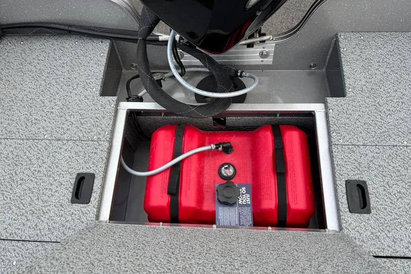 Slide: The Image of 2026 Crestliner 1650 Kodiak boat fuel compartment with red fuel tank. - 6