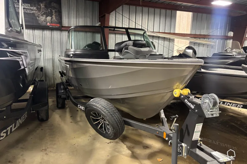 Slide: The Image of 2026 Crestliner 1650 Kodiak boat on trailer in indoor storage. - 7