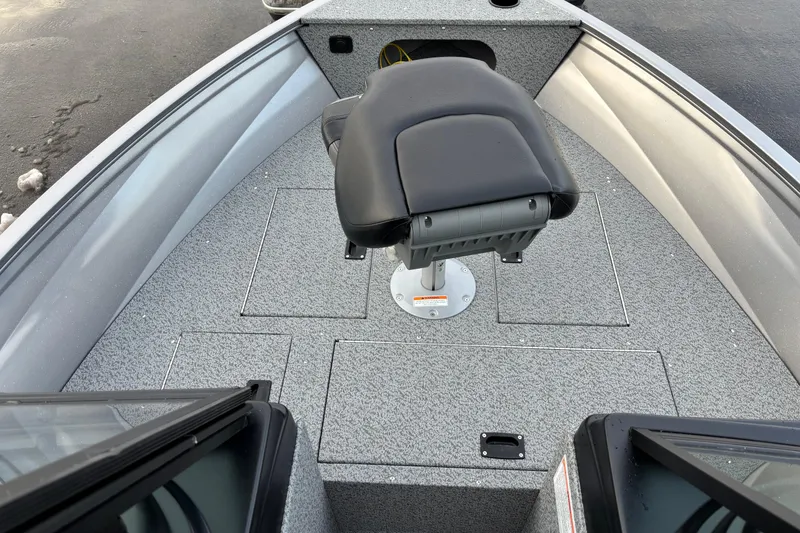 Slide: The Image of 2026 Crestliner 1650 Kodiak boat interior with swivel seat and storage compartments. - 8