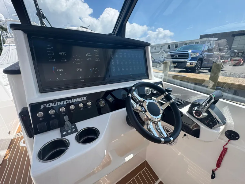 Slide: The Image of 2025 Fountain 39 DX boat dashboard with advanced controls and digital displays. - 12