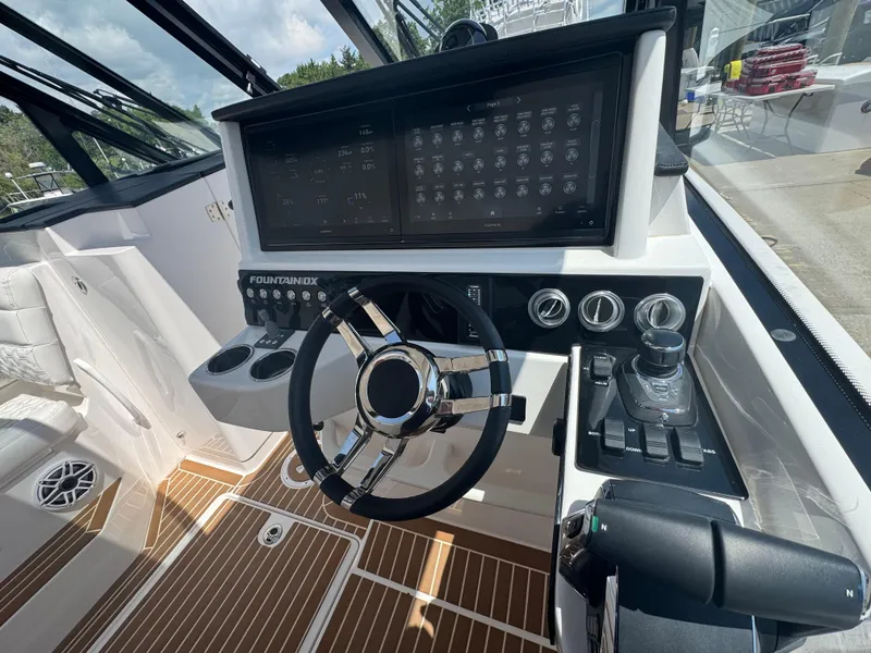 Slide: The Image of 2025 Fountain 39 DX boat cockpit with modern steering and control panel. - 13