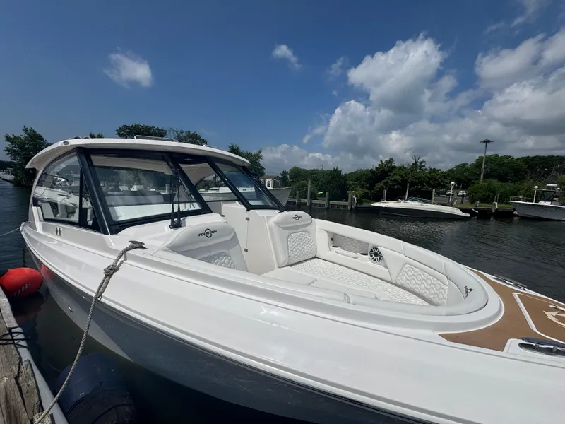 Slide: The Image of 2025 Fountain 39 DX boat docked under a partly cloudy sky. - 2