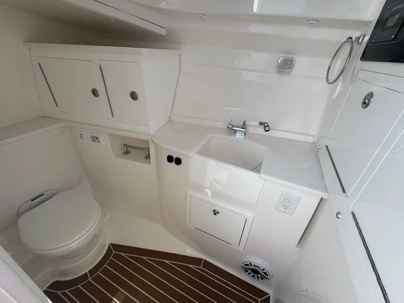 Slide: The Image of 2025 Fountain 39 DX boat bathroom with sink, toilet, and storage cabinets. - 25