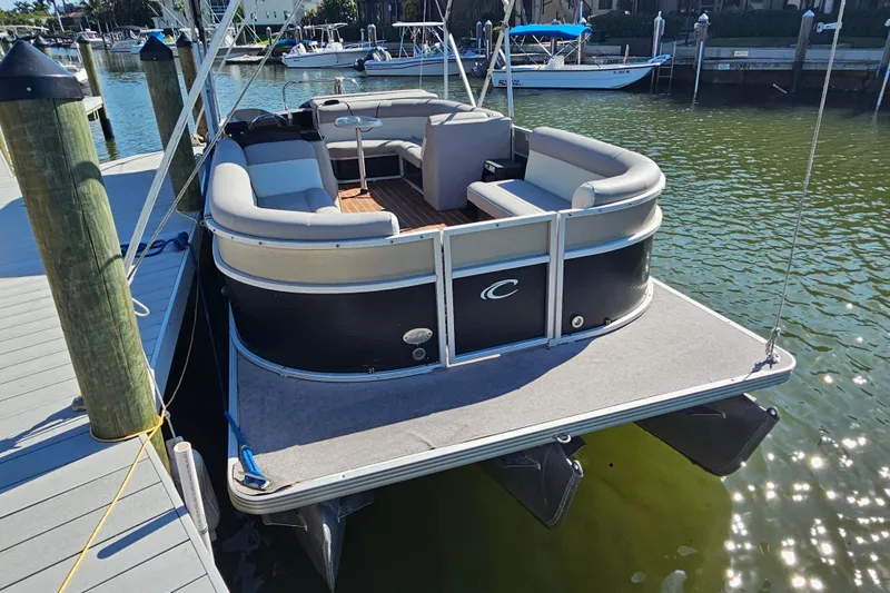 The Image of 2013 Crest 22 TriToon boat docked, featuring spacious seating and sleek design. - 0