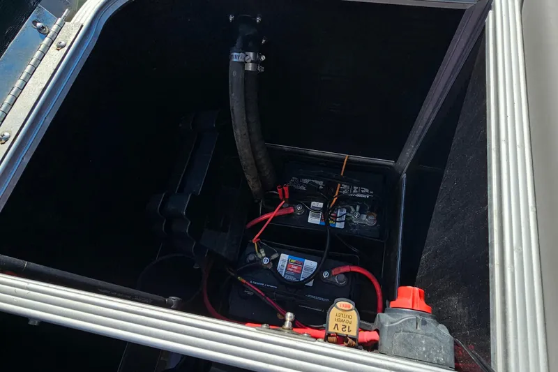 Slide: The Image of Battery compartment of a 2013 Crest 22 TriToon boat with visible wiring. - 14