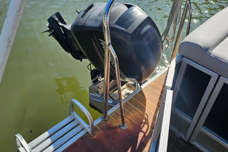 Slide: The Image of 2013 Crest 22 TriToon boat with outboard motor on water. - 2