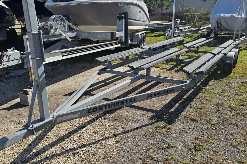 Slide: The Image of 2013 Crest 22 TriToon trailer parked outdoors, featuring Continental branding. - 20