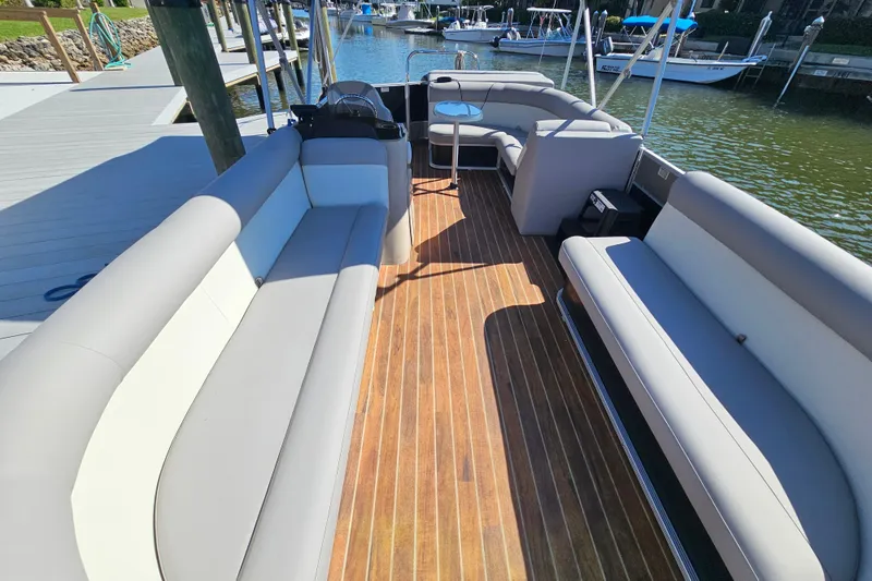 Slide: The Image of 2013 Crest 22 TriToon boat interior with spacious seating and wooden deck. - 6