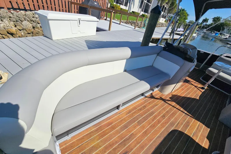 Slide: The Image of 2013 Crest 22 TriToon boat interior with gray seating and wooden deck. - 7