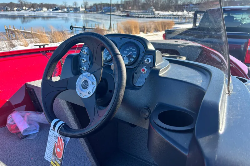 Slide: The Image of Steering console of 2026 Crestliner 1650 Kodiak boat with lake view in background. - 12
