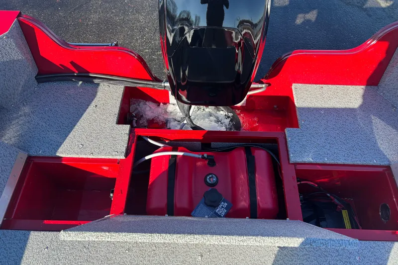 Slide: The Image of 2026 Crestliner 1650 Kodiak boat interior with red compartments and motor. - 2