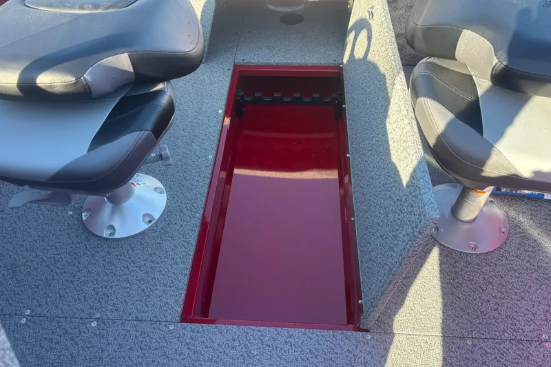 Slide: The Image of 2026 Crestliner 1650 Kodiak boat interior with open storage compartment and seating. - 3