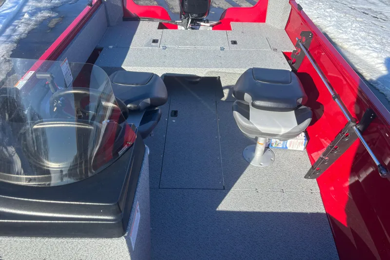 Slide: The Image of 2026 Crestliner 1650 Kodiak boat interior with seating and steering wheel, featuring red and gray design. - 6