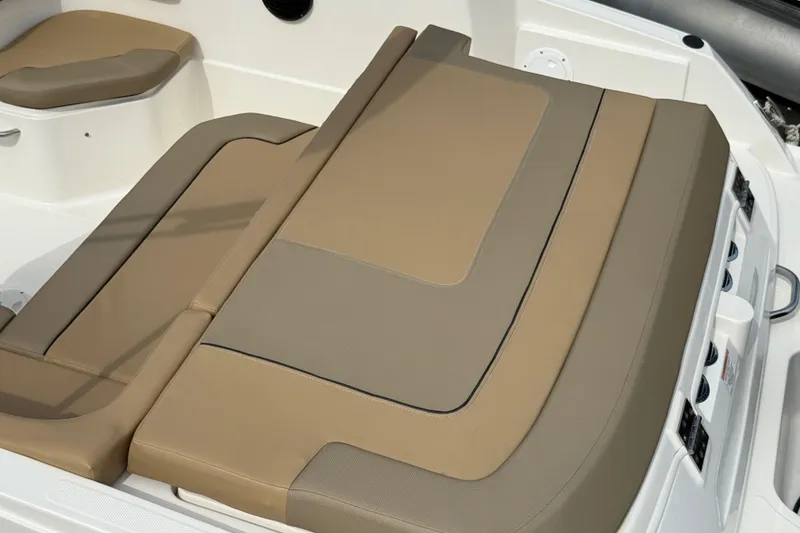 Slide: The Image of 2025 Bayliner VR6 Bowrider OB, tan and beige seating detail, luxurious boat interior. - 10