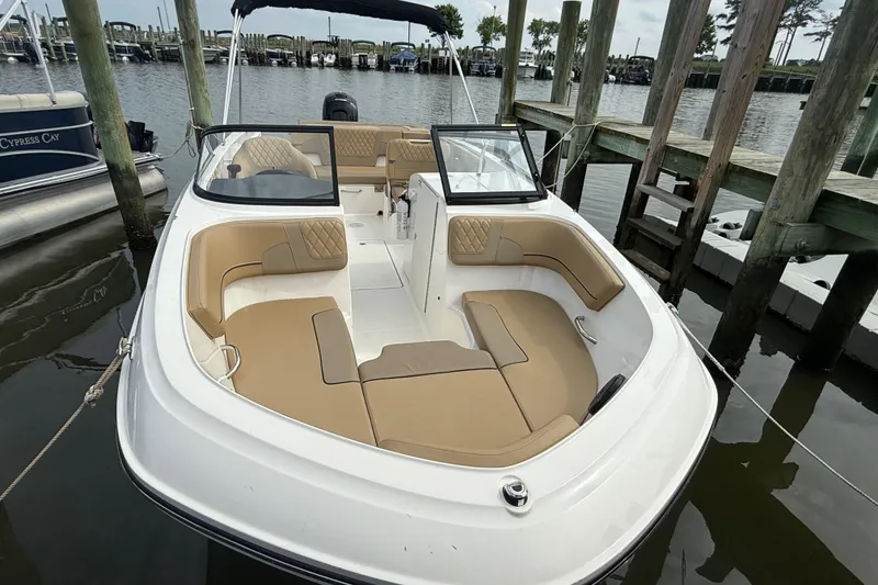 Slide: The Image of 2025 Bayliner VR6 Bowrider OB docked, featuring spacious seating and sleek design. - 2