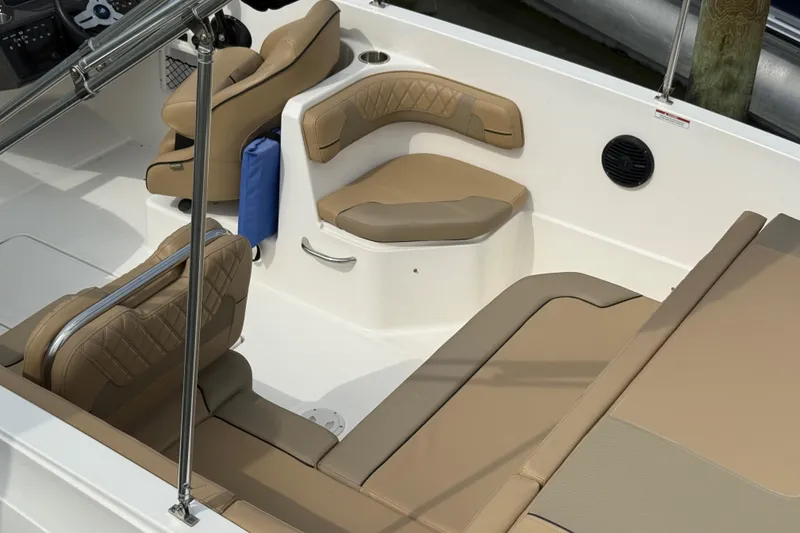 Slide: The Image of 2025 Bayliner VR6 Bowrider OB interior with tan seating and modern design. - 9
