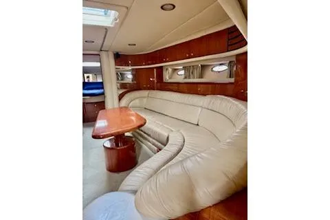 Slide: The Image of Interior of 2001 Sea Ray Sundancer 540 yacht with plush seating and wooden table. - 13