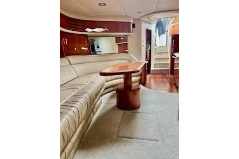 Slide: The Image of Luxurious interior of 2001 Sea Ray Sundancer 540 yacht with plush seating and elegant wood finishes. - 14