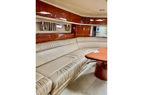 Slide: The Image of Luxurious interior of 2001 Sea Ray Sundancer 540 yacht with leather seating and wooden accents. - 15
