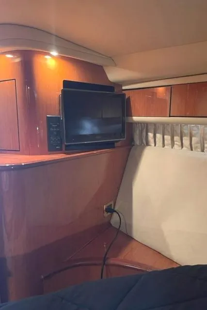 Slide: The Image of Interior of 2001 Sea Ray Sundancer 540 yacht with TV and wooden cabinetry. - 31